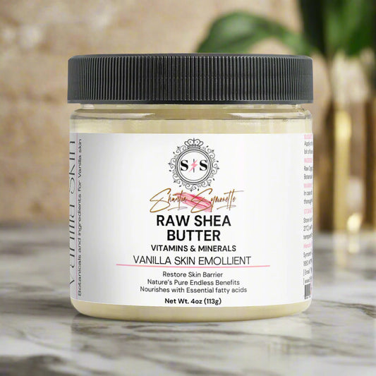 Jar of raw shea butter with a black lid on a white background